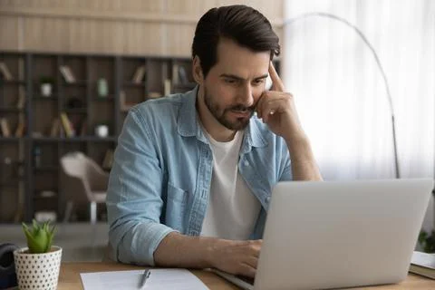 Young man freelancer concentrate on solving business problem using laptop 스톡 사진
