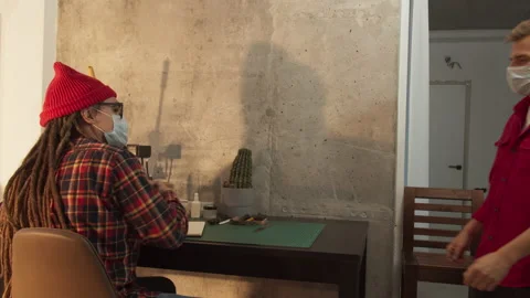 Young man freelancer designer working in office. People wear protective face Stock Footage 140204148