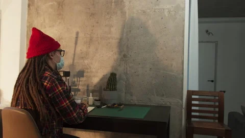 Young man freelancer designer working in office. People wear protective face Stock Footage 142454572