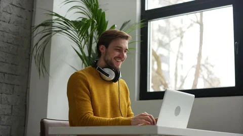Young man freelancer entrepreneur using laptop online working from home Video stock 229776382