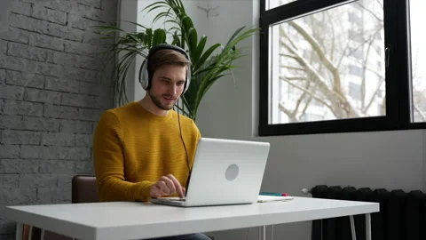 Young man freelancer entrepreneur using laptop online working from home Video stock 229776970
