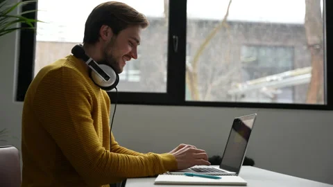 Young man freelancer entrepreneur using laptop online working from home Video stock 229777869