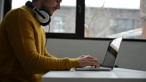 Young man freelancer entrepreneur using laptop online working from home Stock Footage 229777957