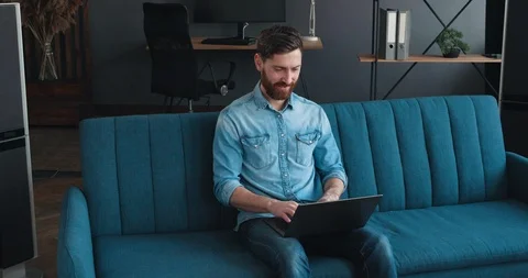 Young Man Freelancer or Startuper using Laptop, studying online, working from Vídeo Stock 127462285