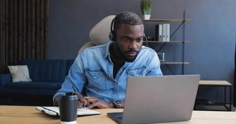 Young Man Freelancer or Student using Laptop, studying online, working from home Stock Footage 147051174