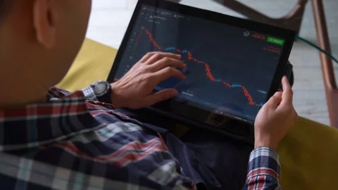 Young man freelancer sitting on the sofa in cozy room and checking Stock Footage 124307581