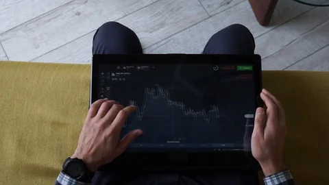 Young man freelancer sitting on the sofa in cozy room and checking Stock Footage 124307684