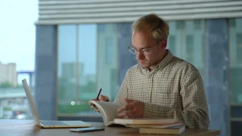 Young man freelancer student using laptop studying online working from home in Stock Footage 132133261