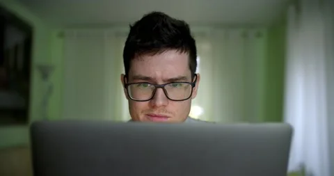Young man freelancer student using laptop studying online working from home in Stock Footage 135615300