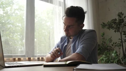 Young man freelancer student using laptop studying online working from home Stock Footage 139448352