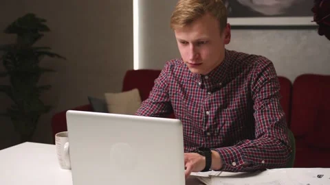 Young man freelancer student using laptop studying online working from home on Stock Footage 146598944