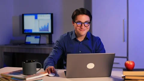 Young man freelancer student using laptop studying online working from home Vidéo 262070832