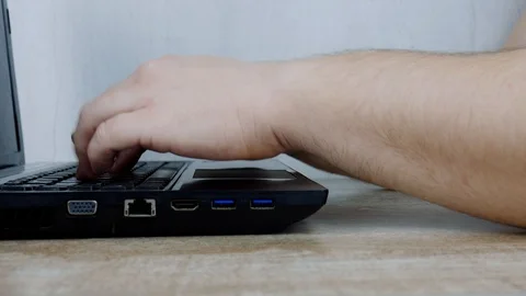 Young Man Freelancer Using Laptop, Typing, Scrolling, Surfing Web 動画素材 128005097