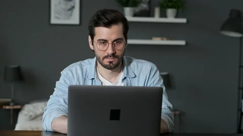 Young Man Freelancer Using Laptop, Typing, Scrolling, Surfing Web Stock Footage 143478335