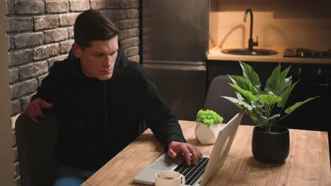 Young man freelancer using laptop studying online working from home, focused man Stock Footage 148384503