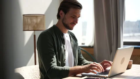 Young man freelancer using laptop online working from home in internet Stock Footage 220867745