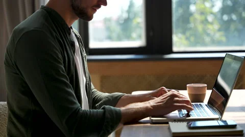 Young man freelancer using laptop online working from home in internet Stock Footage 220868582