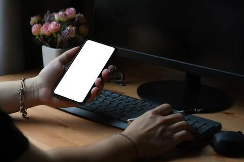 Young man freelancer working with computer and using smart phone at home office. Foto stock
