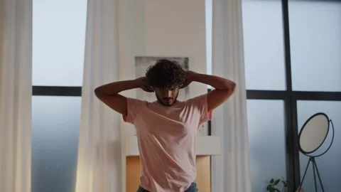 Young man freelancer working remote at home doing pause. Indian guy turn off Stock Footage 252609427