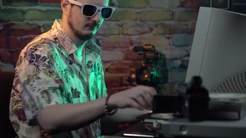 Young Man in Front of Desktop Computer Taking Out DVD From Player Cleaning With Video stock 305834078