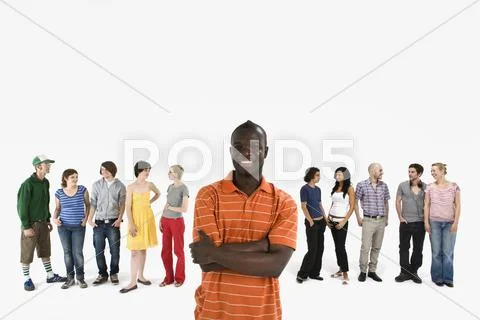 A young man in front of a row of men and women Stock Photos