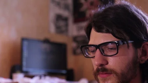 A young man with a gadget lying on sofa in his room 動画素材 82211400