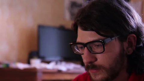 A young man with a gadget lying on sofa in his room 動画素材 82211420