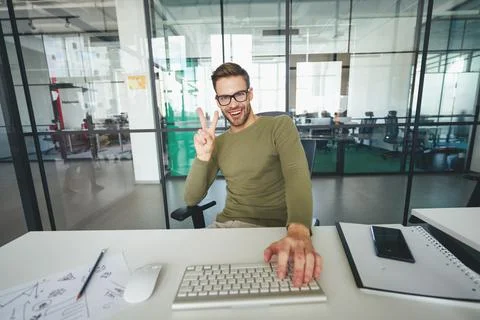 Young man gesturing actively in front of a web-camera Stock Photos