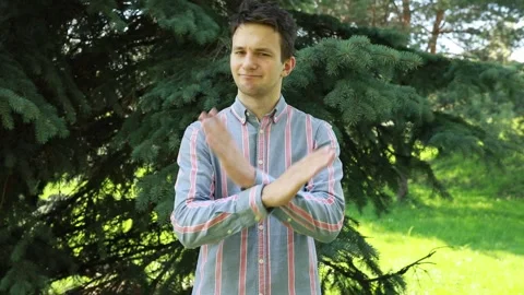 Young Man Gesturing No With Hands in Sunny Park During Summer Afternoon Video stock 274129026