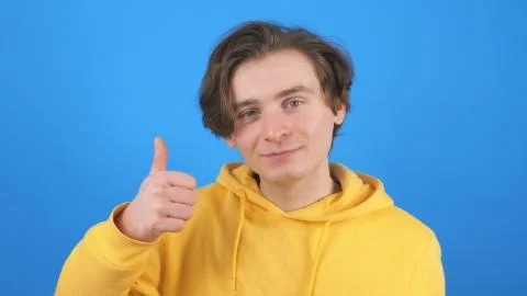 Young man gesturing thumb up Stock Photos