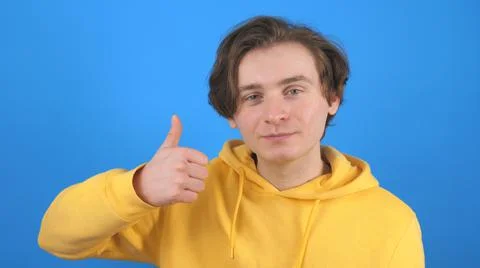 Young man gesturing thumb up Stock Photos