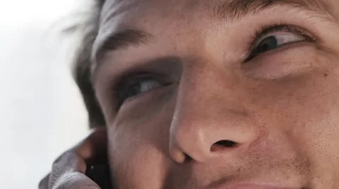 Young Man get a phone call and smile in Slow-Motion Stock Footage 54936418