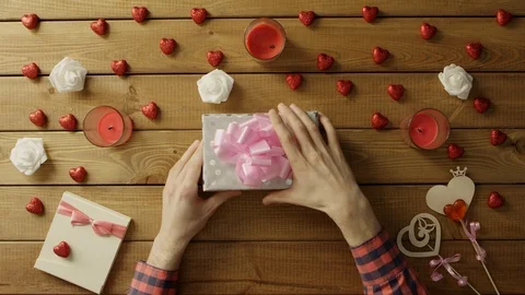 Young man gets fidget spinner toy as valentine day present, top view Stock Footage 87973717