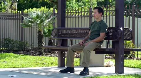Young man gets frustrated waiting for bus, 4K Stock Footage 48703125