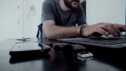 Young man gets home immediately goes to laptop computer Stock Footage 77092316
