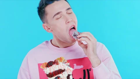 The young man gets pleasure from tasting dessert Stock Footage 89628078
