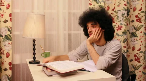 Young man getting bored while studying Stock Footage 3438325