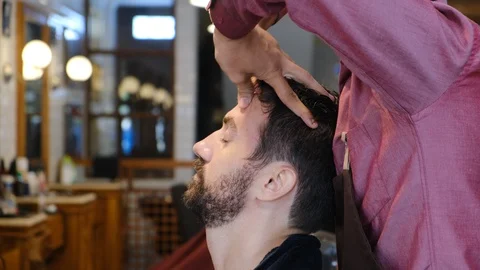 Young man getting head massage in a barber shop or hair salon after haircut Stock-Footage 130123764