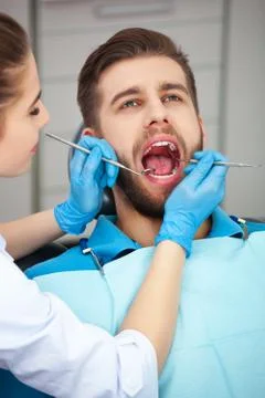 Young man getting his teeth checked by a dentist. Foto stock