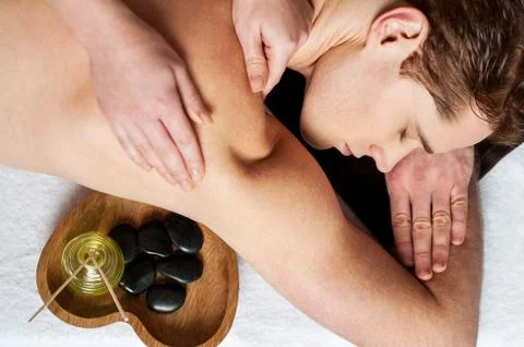 Young man getting massage Stock Photos
