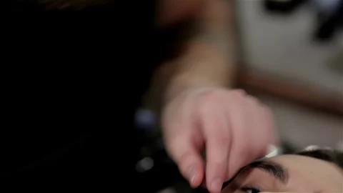 Young man getting an old-fashioned shave at the barber shop Stock Footage 252661057