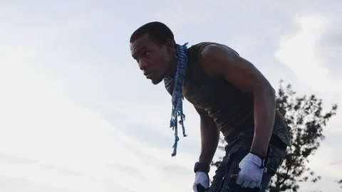 Young man getting ready to ride rollerblades Stock Footage 113109992