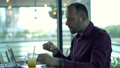 Young man getting stomach ache during meal in cafe Stock Footage 70706247
