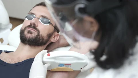 Young man getting underarm laser hair removal epilation. IPL treatment in Stock-Footage 141845873