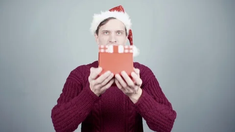Young man gives a gift. Congratulate New Year, Merry Christmas, presents gifts Stock-Footage 70260997
