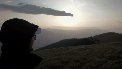 Young man in glasses and a baseball cap hiking in mountain outdoor nature Stock-Footage 88956935