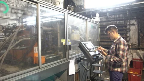 Young man in glasses with and tablet in his hands monitoring milling machine Stock Footage 77820667
