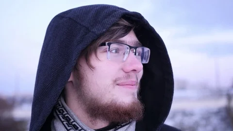 A young man in glasses with a beard to look away. turn one's face to the camera Video stock 85443317