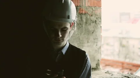 Young man in glasses on the building project Stock Footage 63849579