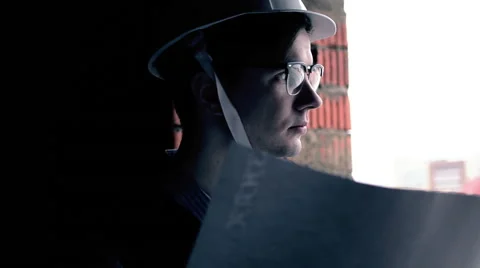 Young man in glasses on the building project Stock Footage 63849869